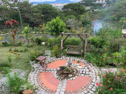 a garden with a bench sitting on a patio at Romantic house on a pine hill Dalat in Xuan An