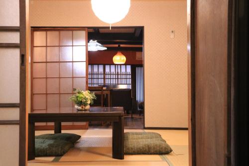 a dining room with a table and a room with at Kyonoyado Nijo Yumeya in Kyoto