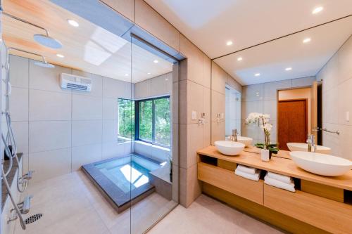 a bathroom with two sinks and a shower at Sakura 88 - Luxury Villa - 280sqm 4 bedrooms in Hakuba