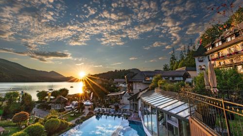 a view of a resort with a pool and a lake at Waldhof Fuschlsee Resort in Fuschl am See