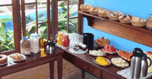 a table with plates of food on it at Pousada Vistamar in Paraty