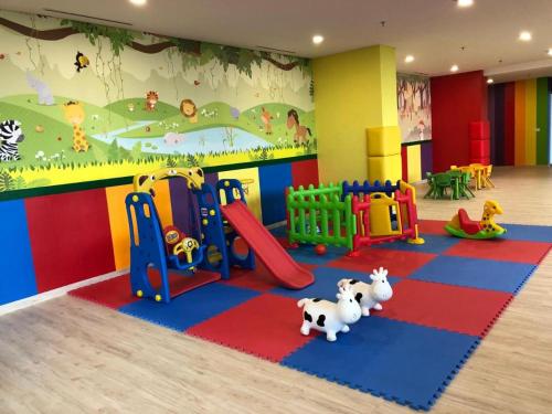 a childrens play room with a playground and toys at Gold Coast Apartemen PIK by Dluxx in Jakarta