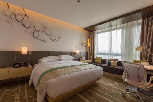 a hotel room with a bed and a couch at Hilton Garden Inn Xi'an High-Tech Zone in Xi'an