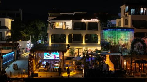 a city street at night with a building at Shenzhen Semporna Beach Sea View B & B - 深圳较场尾仙本那沙滩海景民宿 in Shenzhen