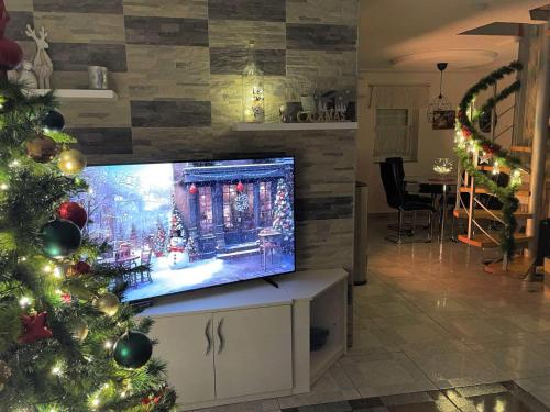a living room with a christmas tree and a television at Villa Tratea - with a heated pool in Tomić Draga