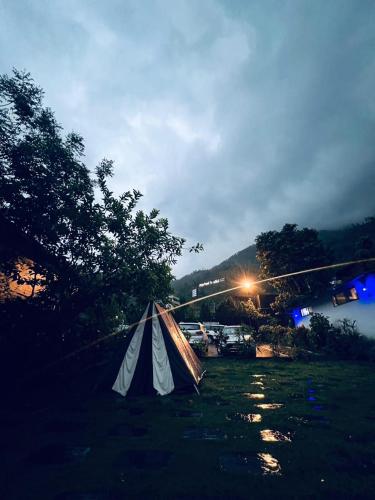 a tent sitting in the middle of a river at Hills and Horizon Resort in Benighāt