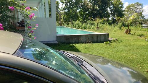 a car parked in front of a swimming pool at Giri Villa in Tangalle