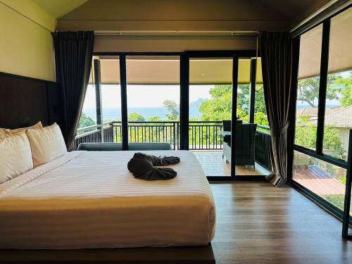 a bedroom with a large bed with a balcony at HIP Seaview Resort @ Phi Phi in Phi Phi Don