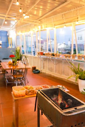 a kitchen with a grill and a table with food at Be.Ho DaLat - Attic in Da Lat