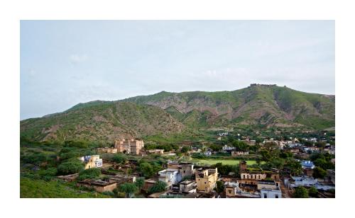 a view of a city with mountains in the background at Patan Mahal in Pātan