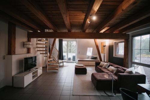 ein Wohnzimmer mit einem Sofa und einem TV in der Unterkunft Komplettes Maisonettehaus in idyllischer Lage in Schwabach