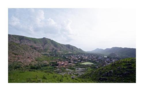 a view of a town in a valley with mountains at Patan Mahal in Pātan