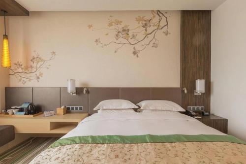 a bedroom with a large bed and a desk at Hilton Garden Inn Xi'an High-Tech Zone in Xi'an