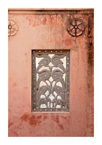 a metal grate on the side of a wall at Patan Mahal in Pātan