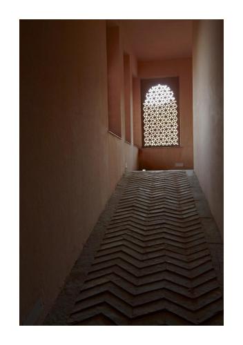 an empty hallway with a window in a building at Patan Mahal in Pātan