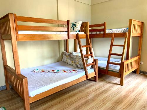 two bunk beds in a room with at Hana Natsu Resorts Beach & Hotel in Morong