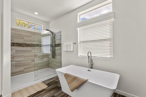 a white bathroom with a tub and a shower at Andante Trail - Unit A - Red Rock Retreat in Sedona
