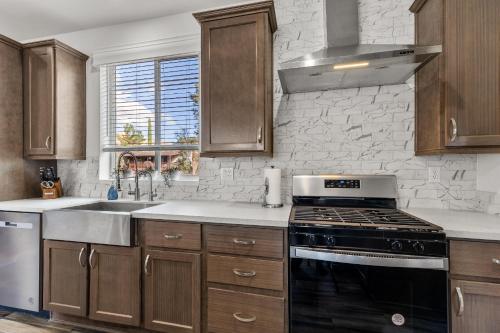 a kitchen with wooden cabinets and a stove top oven at Andante Trail - Unit A - Red Rock Retreat in Sedona
