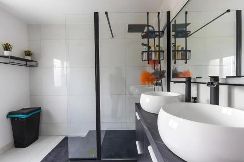 a white bathroom with two sinks and a shower at Le Panorama - Proche Circuit - 5p - Calme in Le Mans