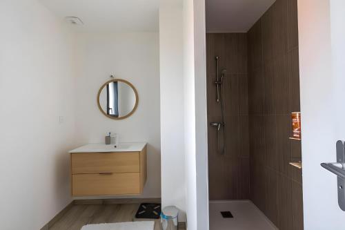 a bathroom with a sink and a shower at Cassiopée - Jacuzzi - Unique - 8p - Rêve au Mans in La Bazoge