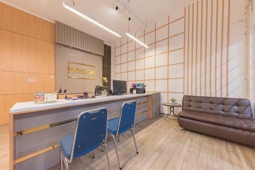 a waiting room with two blue chairs and a counter at Urbanview Hotel Khayrizsan Tasikmalaya by RedDoorz in Tasikmalaya