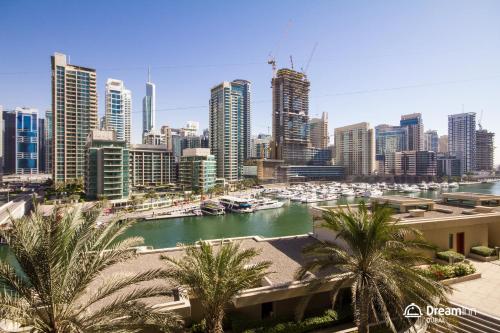 a view of a city with boats in a harbor at Dream Inn Apartments - Al Sahab in Dubai
