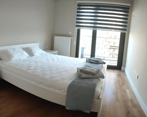 a bedroom with a large white bed and a window at Diamond Apartment 158- Luxury in Skopje in Skopje