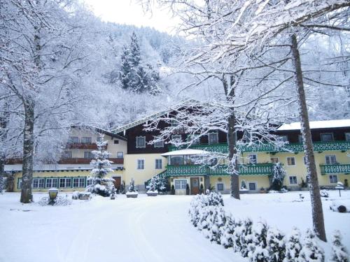a building covered in snow with snow covered trees at Heilbad Burgwies in Stuhlfelden