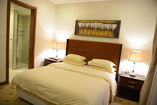 Ліжко або ліжка в номері AlSharq Residence