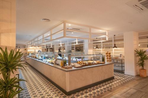 a bakery with a counter with pastries at Gran Hotel Flamingo-Adults Only in Lloret de Mar