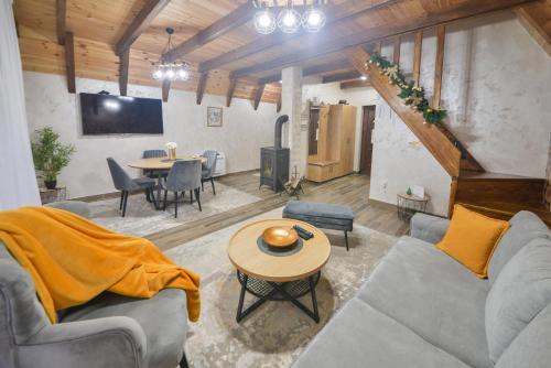 a living room with a couch and a table at Lux Villas Zabljak in Žabljak
