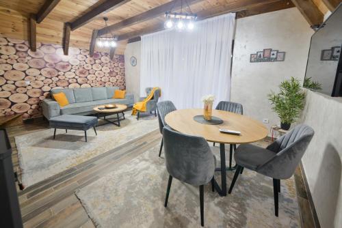 a living room with a table and a couch at Lux Villas Zabljak in Žabljak