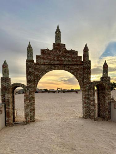 a brick archway in the middle of a beach at Camp Dunes Insolites Sabria in Sabria
