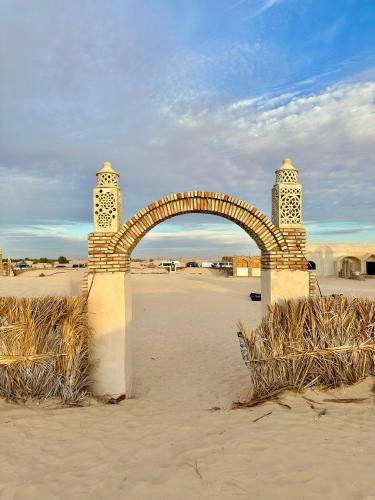 a stone arch in the middle of the desert at Camp Dunes Insolites Sabria in Sabria