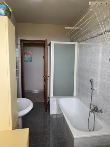 a bathroom with a tub and a toilet and a sink at Casa Carlino in Santo Stefano Belbo