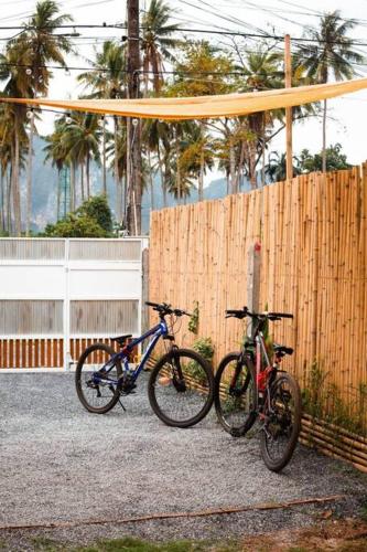 two bikes are parked next to a fence at Baan Bus 81/11 Krabi in Ao Nang Beach