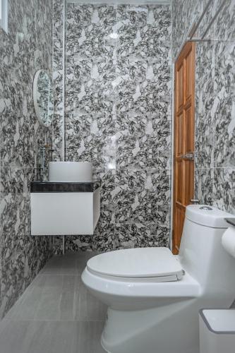 a bathroom with a toilet and a black and white wallpaper at 哦先生的海景别墅 Aoyon Beach in Phuket Town