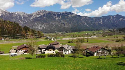 a house in a field with mountains in the background at Haus Nampolach 