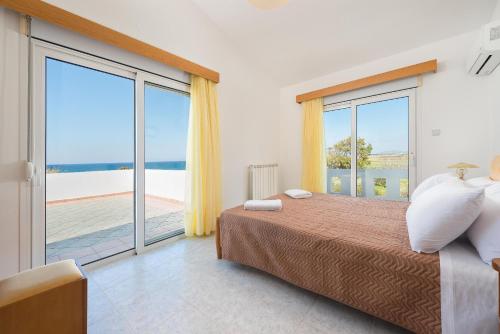 1 dormitorio con cama y ventana grande en Villa Sunset en Kalavárda