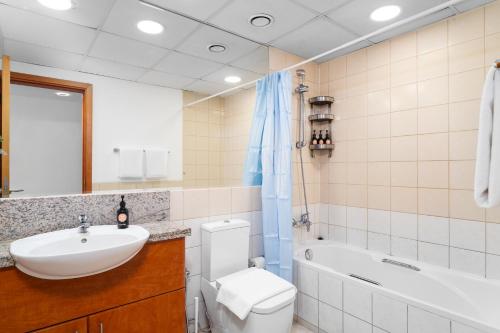 a bathroom with a sink and a toilet and a tub at EasyGo - Al Samar 4 - 2 Bedroom & Maid in Dubai