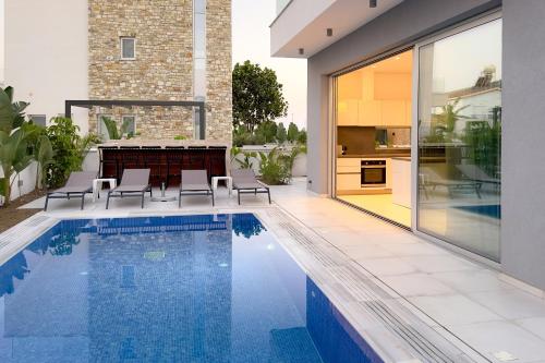 a swimming pool in the backyard of a house at City Napa Seaview Villas - Villa 8 in Ayia Napa