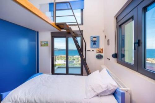a bedroom with a bed with a ladder and windows at Villa Pasiphae in Stalos
