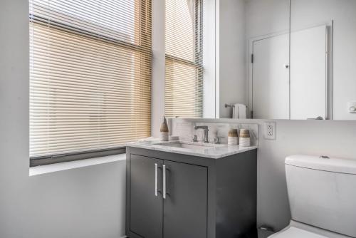 a bathroom with a sink and a toilet at Open Back Bay 1BR w Gym nr the Common BOS-2 in Boston