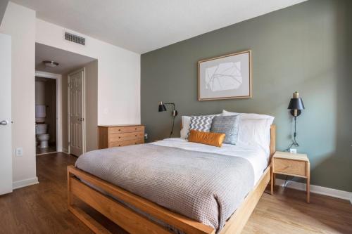 a bedroom with a large bed with a wooden frame at Foggy Bottom 1BR w Gym Pool DM nr World Bank WDC-163 in Washington, D.C.