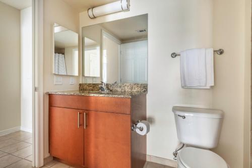 a bathroom with a toilet and a sink and a mirror at Foggy Bottom 1BR w Gym Pool DM nr World Bank WDC-163 in Washington, D.C.