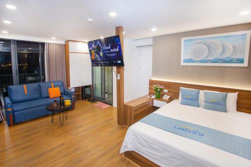 a hotel room with a bed and a television at Lake View Hotel in Hanoi