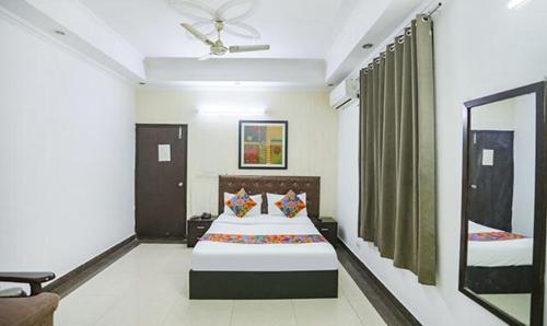 a hotel room with a bed and a mirror at FabHotel F9 H Block Sector 51 in Noida