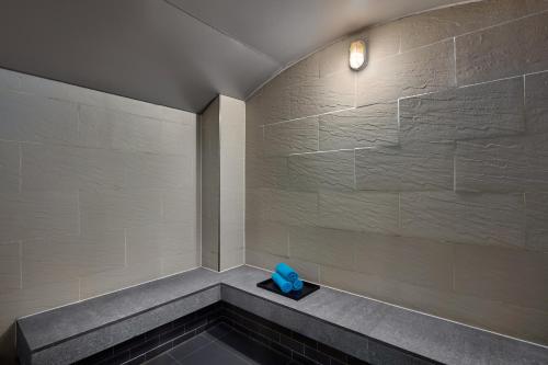 a room with a bench with a blue item on it at Novotel Living Saigon South in Ho Chi Minh City