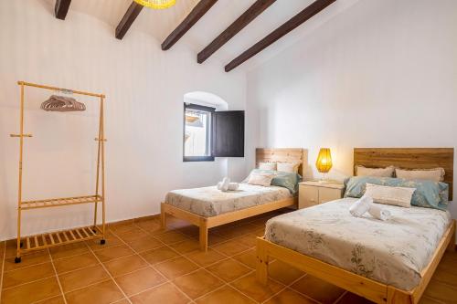een slaapkamer met 2 bedden in een kamer bij La iaia Rosita Preciosa casa tradicional Jávea in Jávea