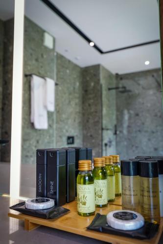 a shelf with four bottles of essential oils on it at Hotel Uji Ftohte Tepelene in Tepelenë